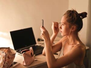 Woman applying makeup before a date night