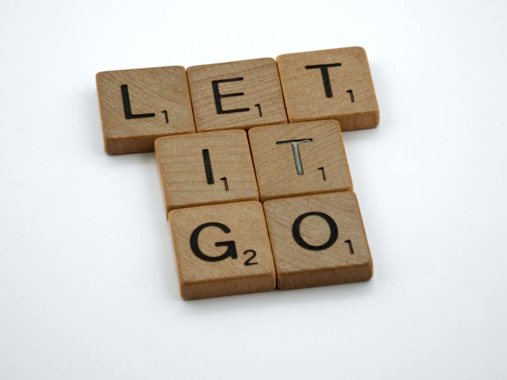 Scrabble pieces placed to spell "Let it go"